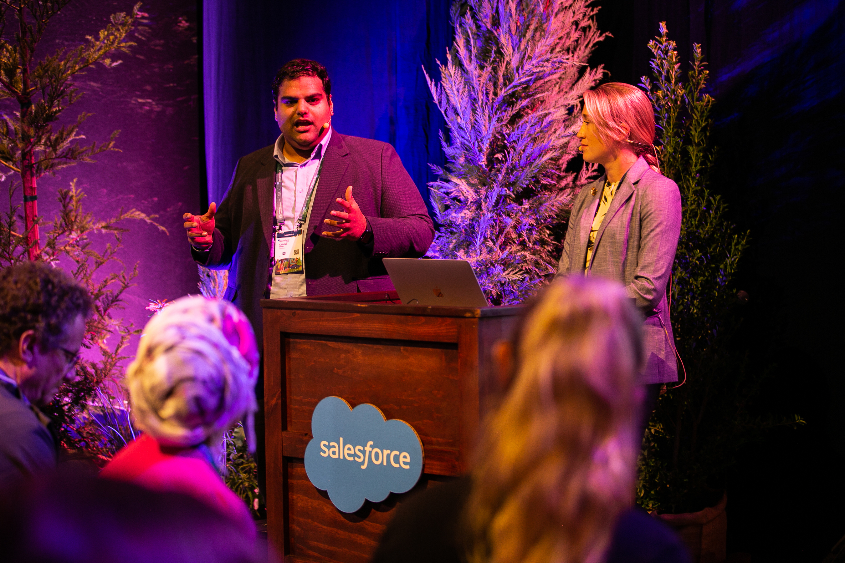 A man and woman speak to a crowd at a recent Dreamforce 22 event. 