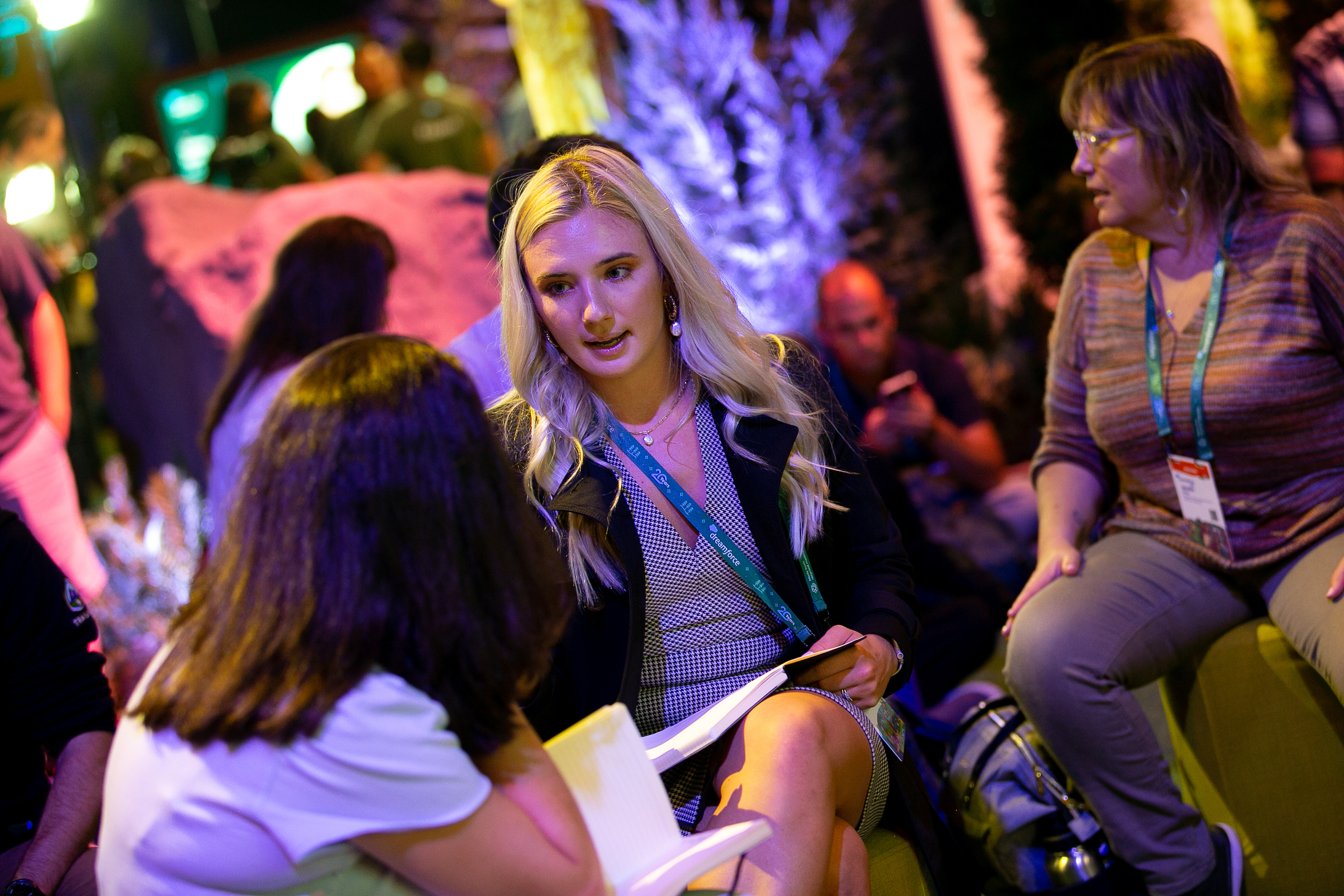 Two women speak to each other during a recent Dreamforce 2022 event. 
