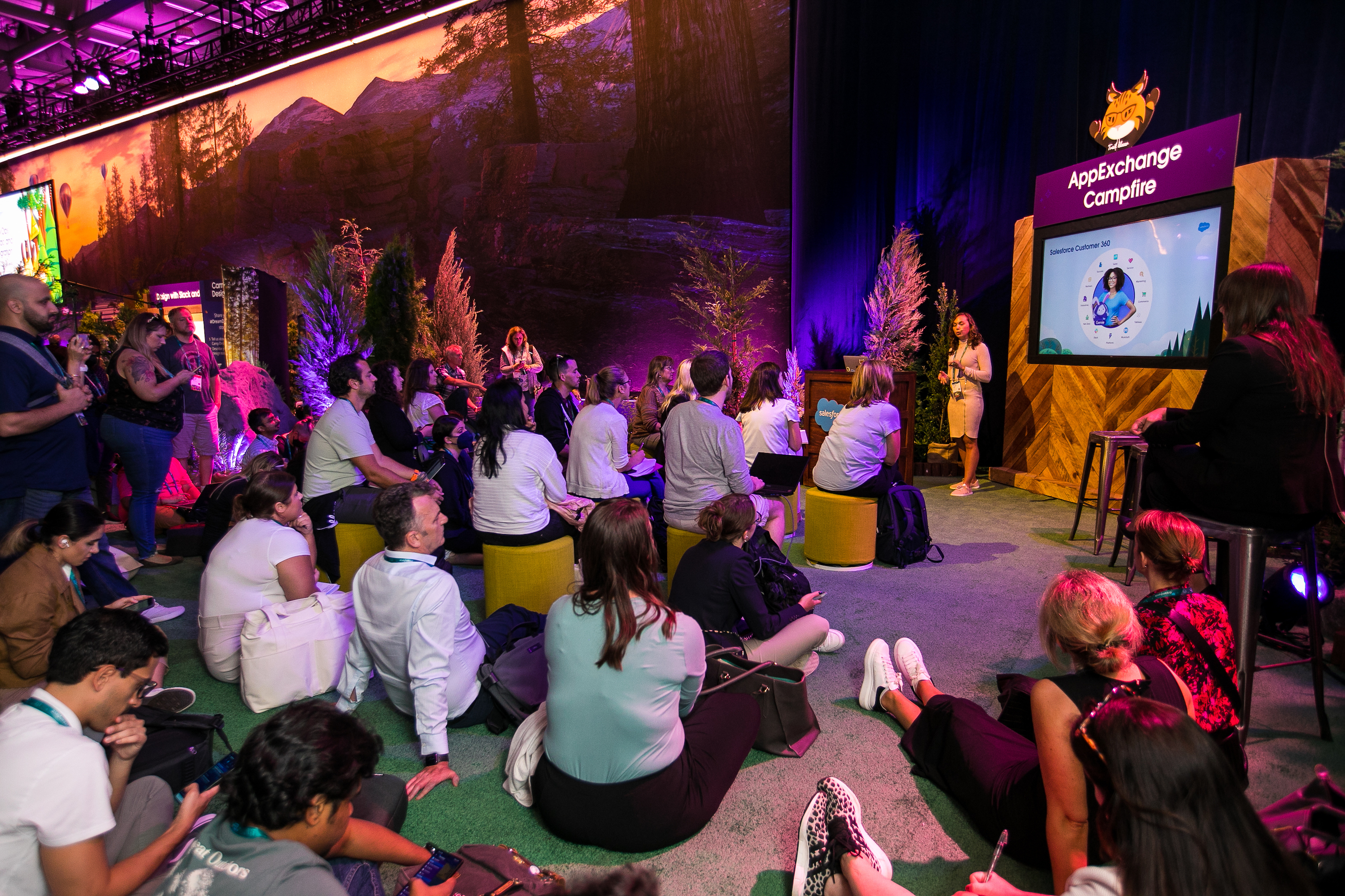 Attendees of Dreamforce 22' sit and listen to a Salesforce employee discuss AppExchange at an event. 