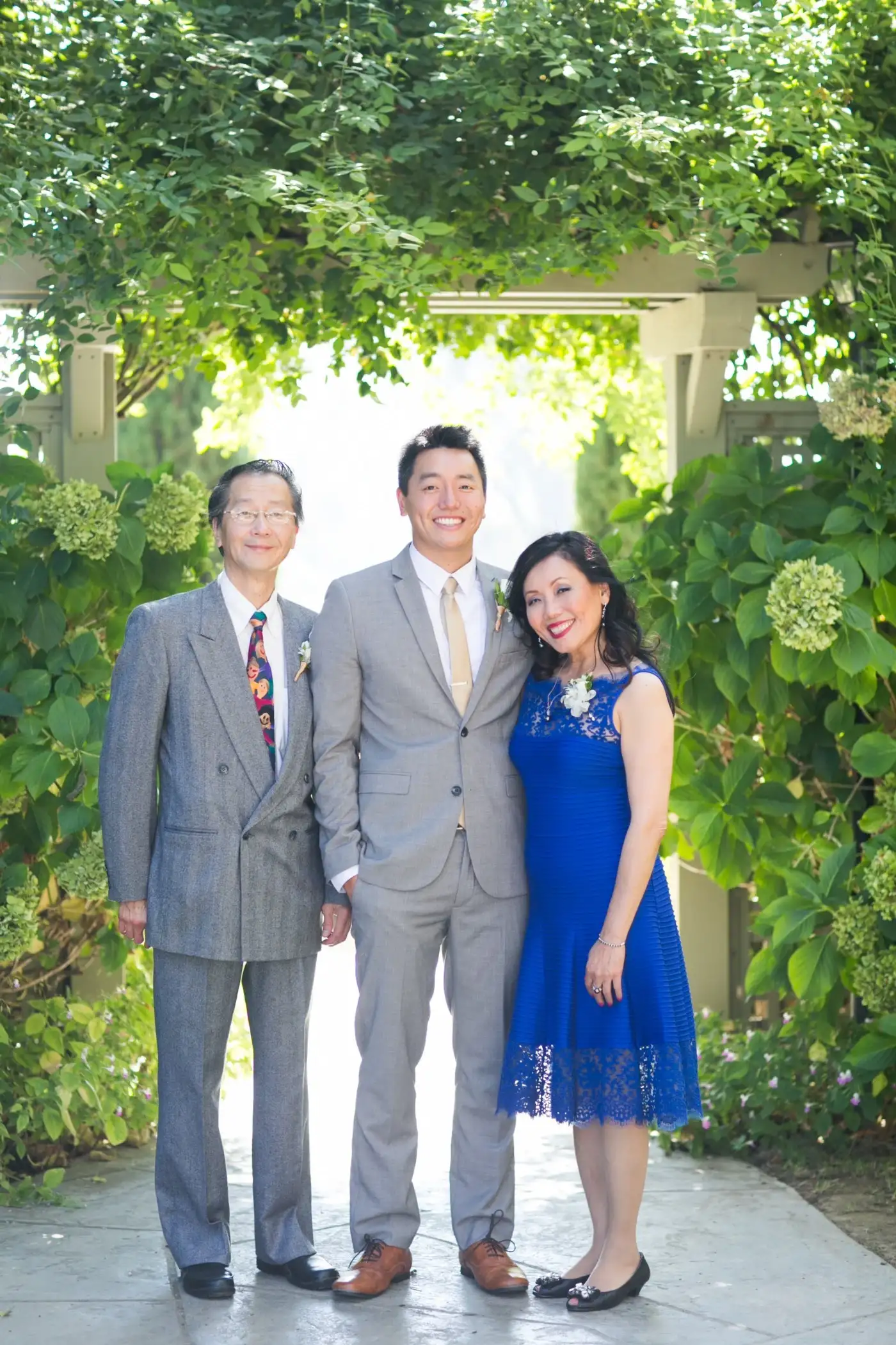 Austin Wang, co-founder of Groove, stands with his parents.
