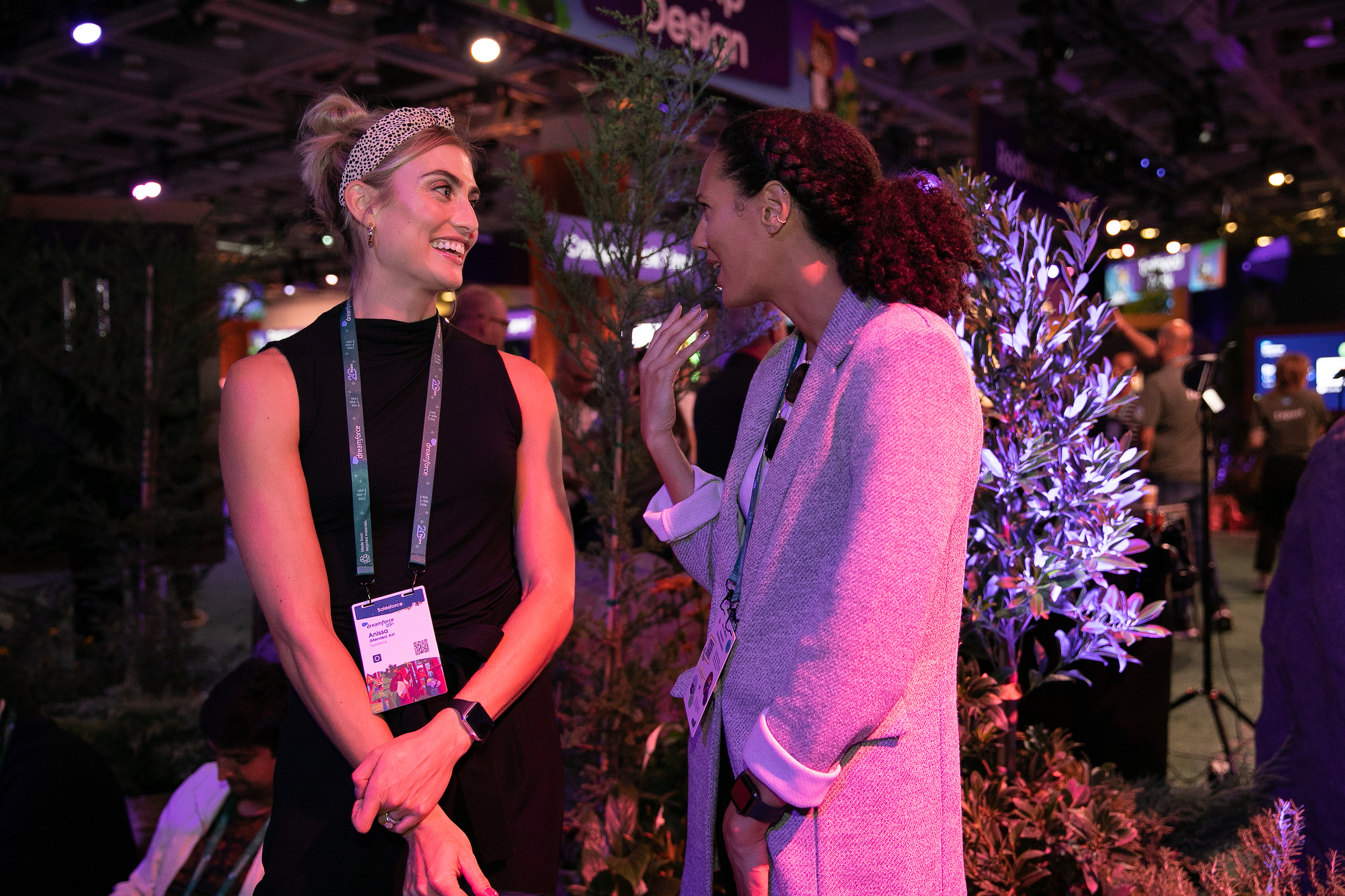 Two women speak to each other at Dreamforce 2022. 