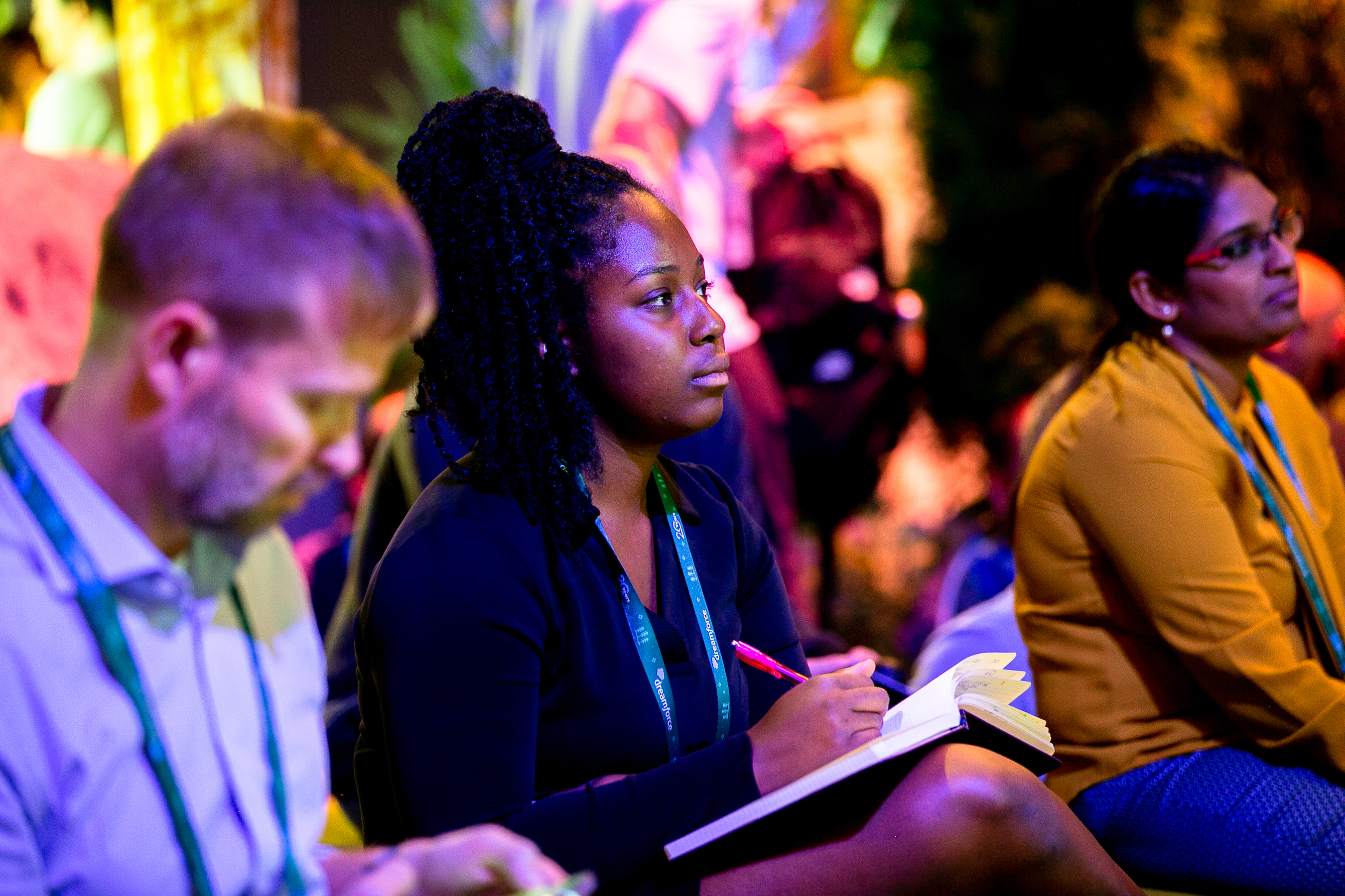 A group of people sit and listen to a Dreamforce 2022 event. 